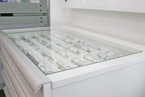 Glass top drawers for retail display in opticians practice designed by Mewscraft