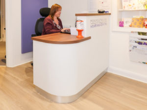 Minimal modern reception desk in white finish designed by Mewscraft